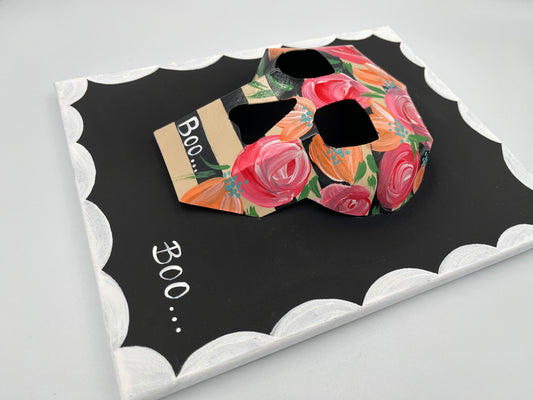 Skull and bloom motif in retro-inspired wall art frame