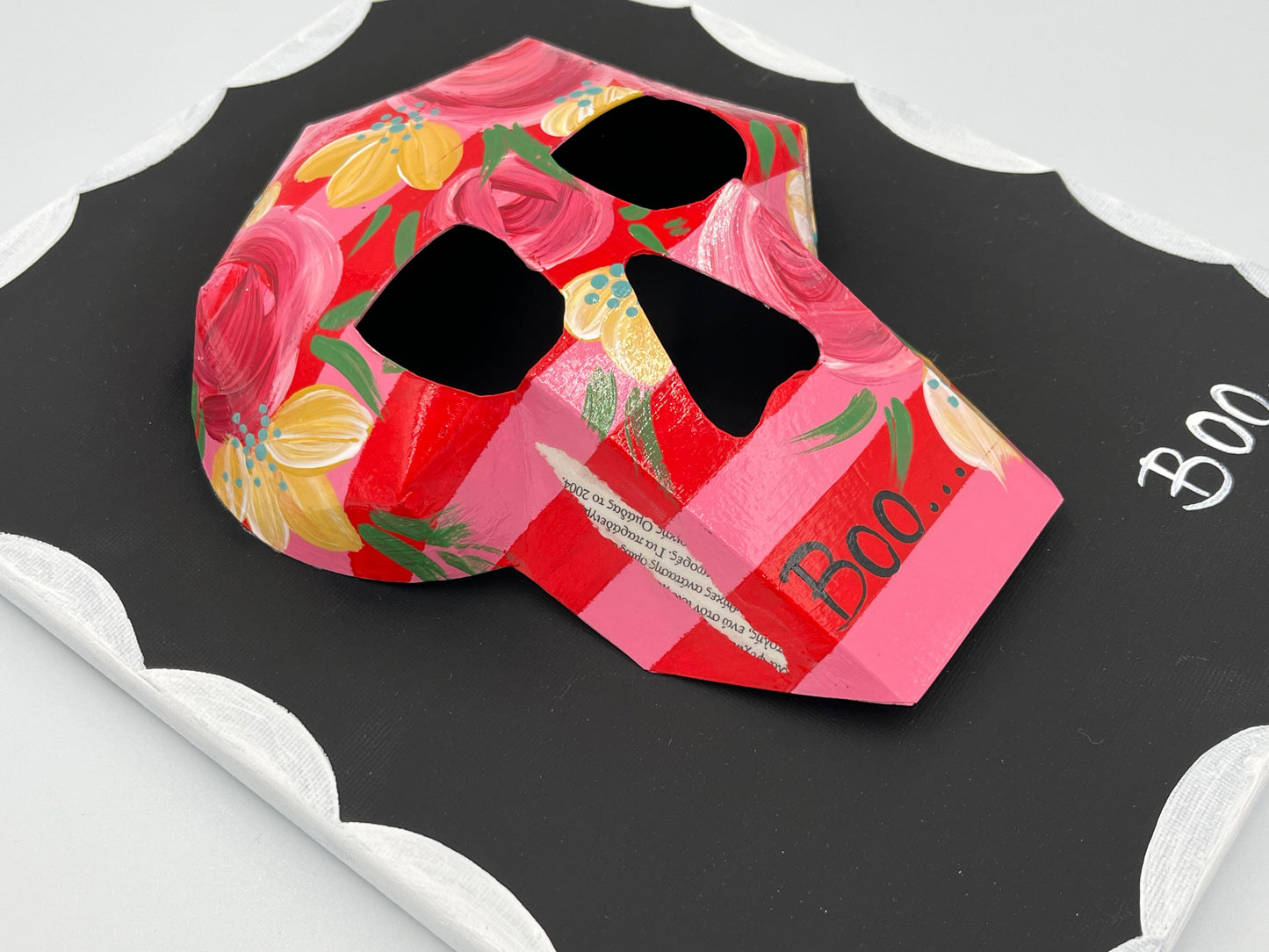 Skull and bloom motif in retro-inspired wall art frame